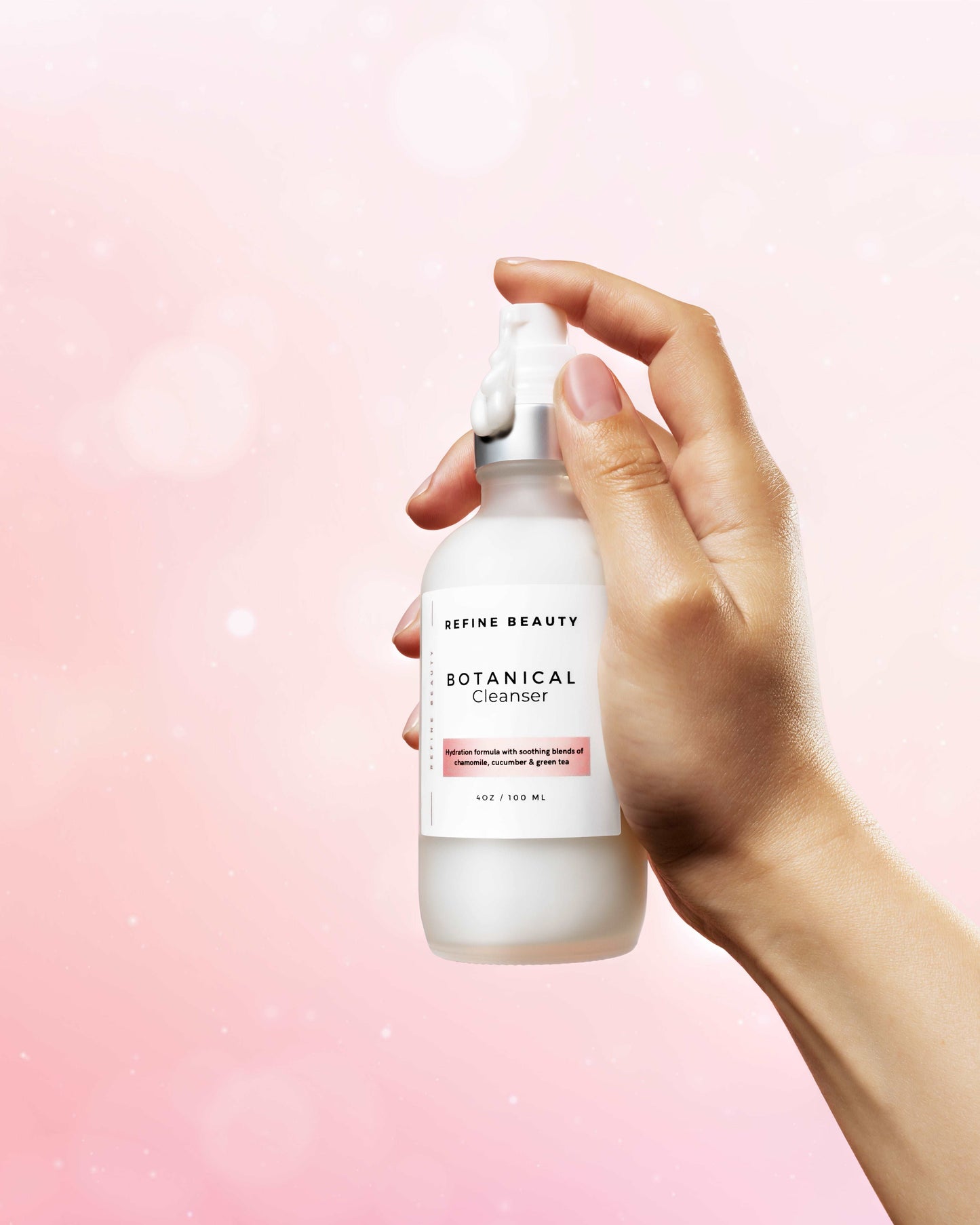 Botanical cleanser has natural ingredients like Chamomile, Aloe, Cucumber, and Japanese Green Tea extracts to nourish and fortify the skin with their antioxidant benefits; bottle held by hand pumping out cleanser