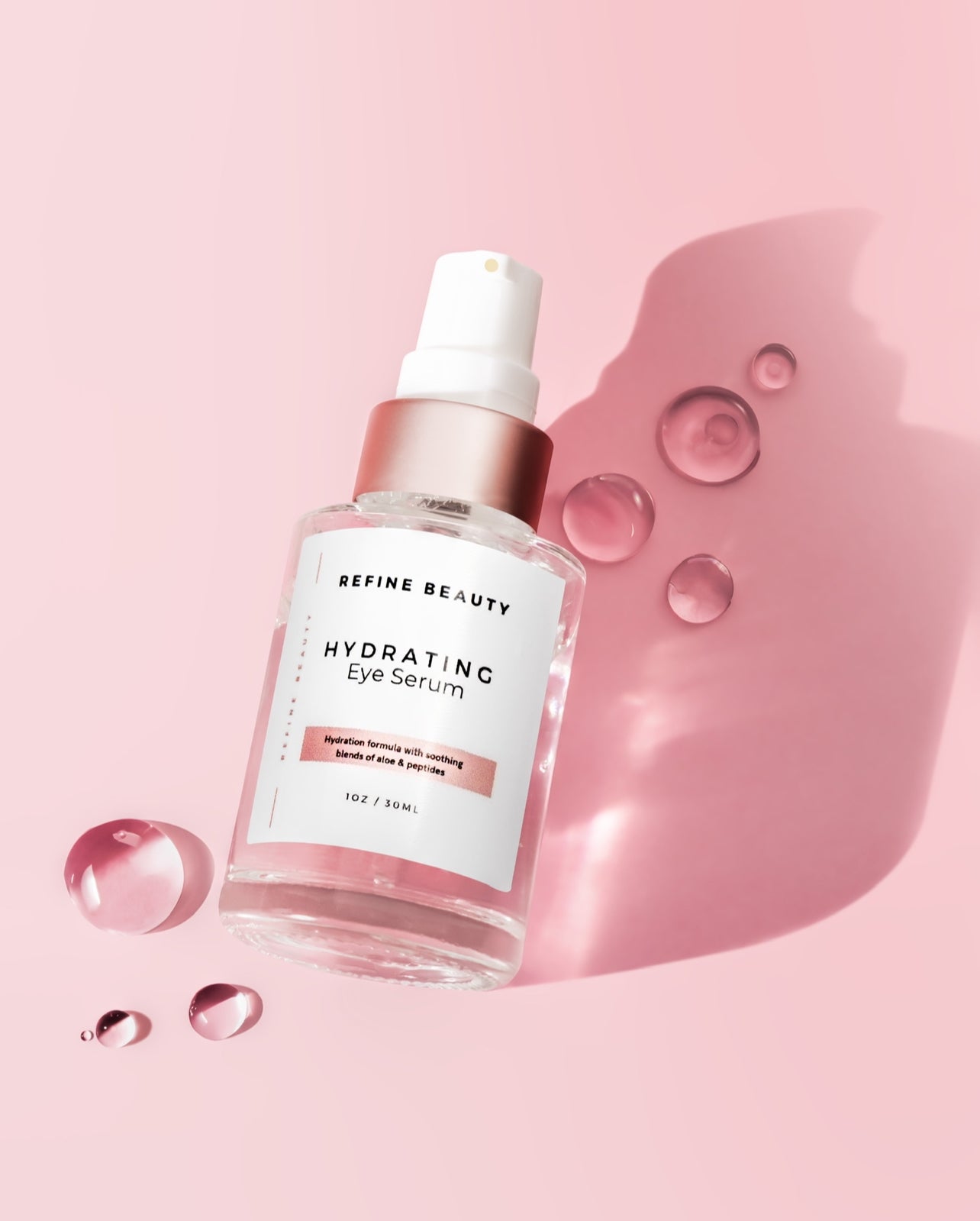 Bottle of Hydrating Eye Serum on pink background with texture drops