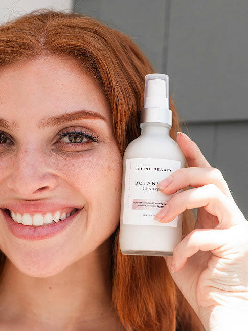 Model holding botanical cleanser with chamomile and green tea for inflammation and redness